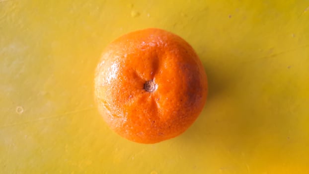 Top angle, Fresh orange fruit on a yellow background photo