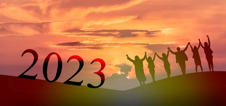 Happy new year 2023, Keep fighting together, Silhouette of 2023 letters on the mountain with business people raised arms in teamwork concept at sunrise. photo