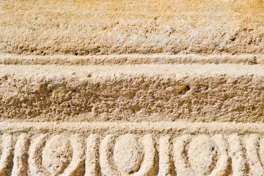 The texture of the yellow sand stone of old stone with patterns and stripes. The background photo