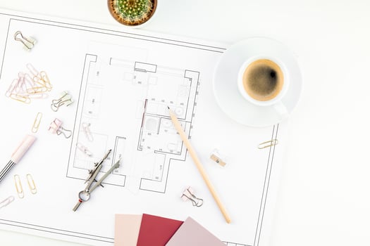 Interior designer table workplace with house plan photo