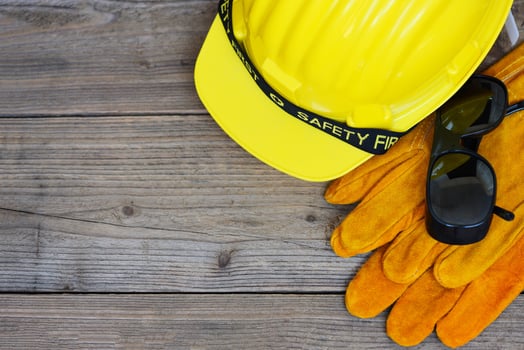 Safety equipment standard construction safety Industrial protective workwear tool with yellow hat safety helmet glasses and gloves on wood background photo