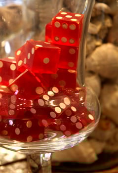 Translucent Red Dice in a Vintage Glass Container photo