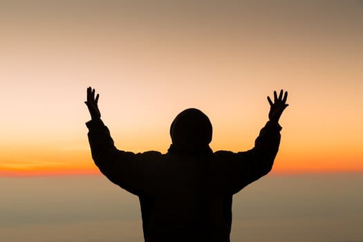 Concept Christian person worship or pray to God. Christian man silhouette with love, faith, devotion to God with sunrise sky background.Male worship God for peace, victory, success with hope. religion photo