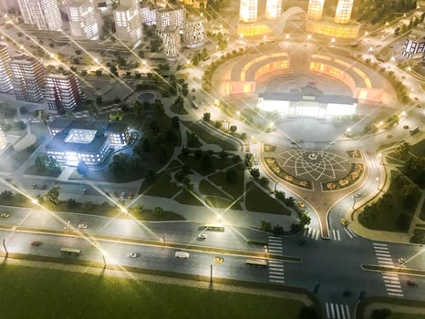 Top view on the toy layout of the city with residential neighborhoods, lanterns, roads, highways, houses, buildings and parking lots, skyscrapers at night. Panorama of the city photo