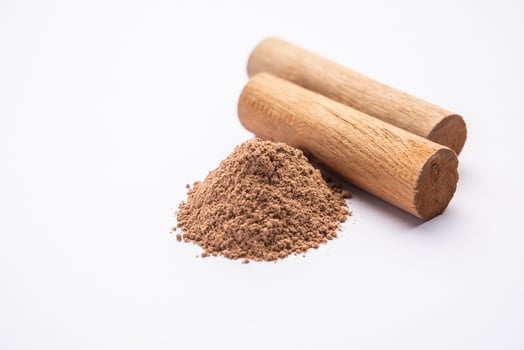 Chandan or sandalwood powder with sticks, perfume or oil which retain their fragrance for decades photo