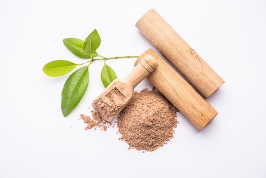 Chandan or sandalwood powder with sticks, perfume or oil which retain their fragrance for decades photo
