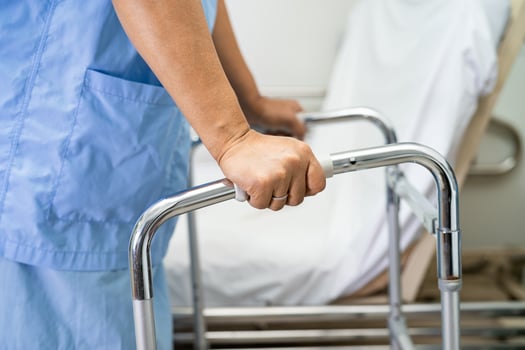 Asian lady patient wearing back pain support belt for orthopedic lumbar with walker. photo