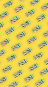 Small stainless steel graters lies on a pastel colored paper. Kitchen accessories. Tools for cooking. Flat lay top view photo