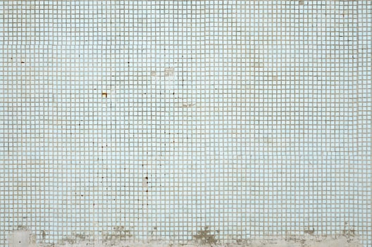 The texture of the old wall, decorated with a lot of square small tiles. Wall in the style of architecture of the Soviet Union photo