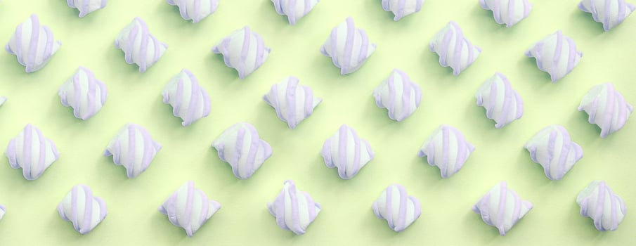 Colorful marshmallow laid out on lime paper background. pastel creative textured pattern photo