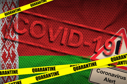 Belarus flag and Covid-19 quarantine yellow tape with red stamp. Coronavirus or 2019-nCov virus photo