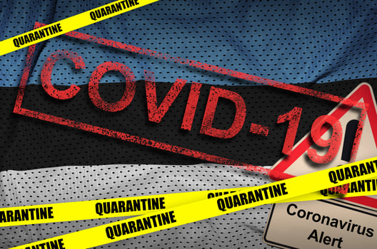 Estonia flag and Covid-19 quarantine yellow tape with red stamp. Coronavirus or 2019-nCov virus photo