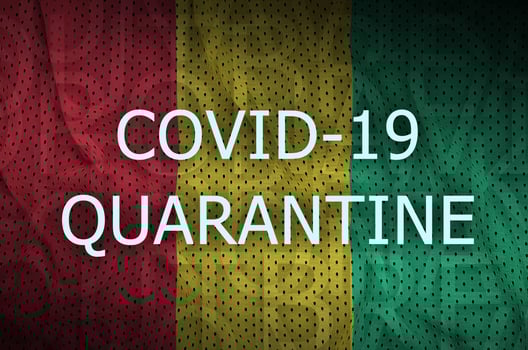 Guinea flag and Covid-19 quarantine inscription. Coronavirus or 2019-nCov virus photo