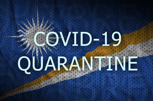 Marshall Islands flag and Covid-19 quarantine inscription. Coronavirus or 2019-nCov virus photo