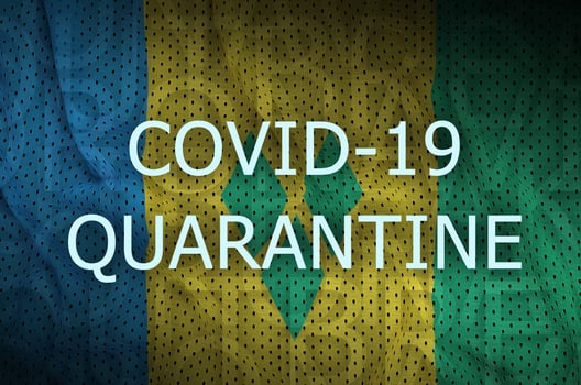 Saint Vincent and the Grenadines flag and Covid-19 quarantine inscription. Coronavirus or 2019-nCov virus photo