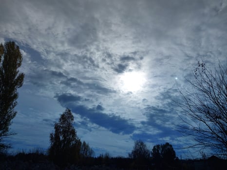 Multi-colored clouds fly over the village photo
