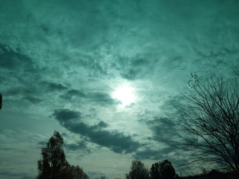 Multi-colored clouds fly over the village photo