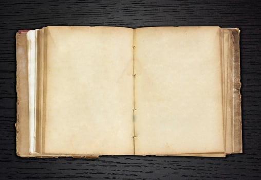 old book open on dark wood background photo