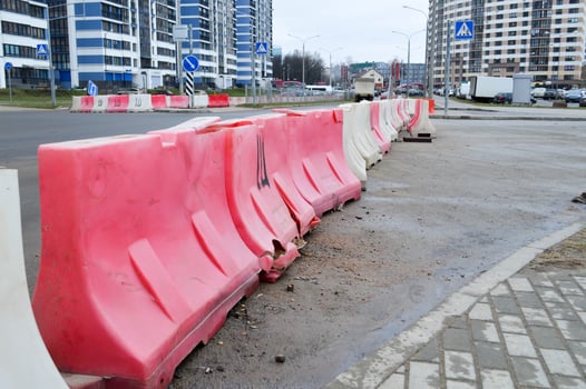 Large plastic red and white enclosure blocks filled with water for road safety during road repairs photo
