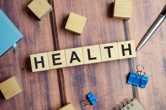 word health made with wooden blocks and pen photo