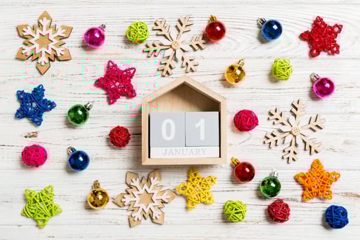 Top view of calendar on Christmas wooden background. The first of January. New Year toys and decorations. Holiday concept photo