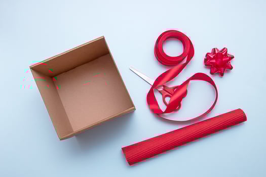 open gift box, scissors, ribbon, wrapping paper, bows to decorate it photo