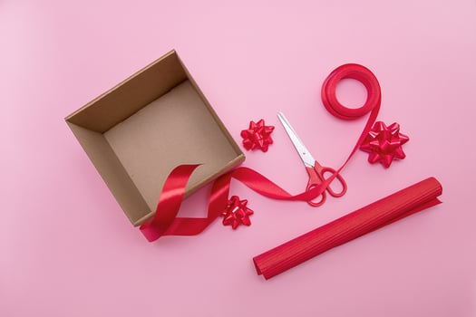 open gift box, scissors, ribbon, wrapping paper, bows to decorate it photo