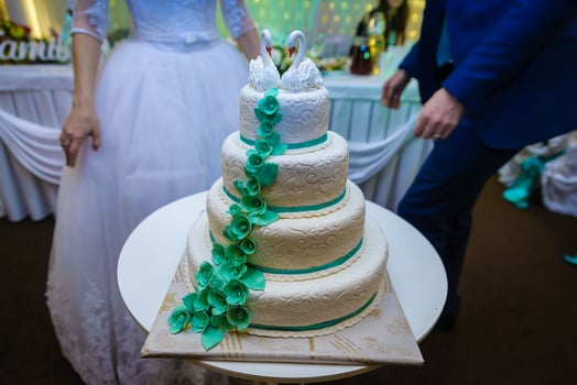 White wedding cake decorated by flowers fruits photo