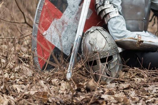Noble warrior. Portrait of one medeival warrior or knight in armor and helmet with shield and sword posing photo