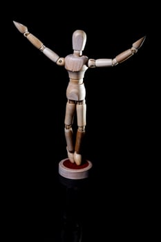 Image of wooden manikin on black background poses different posing photo