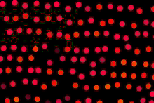 Unfocused abstract red bokeh on black background. defocused and blurred many round light photo