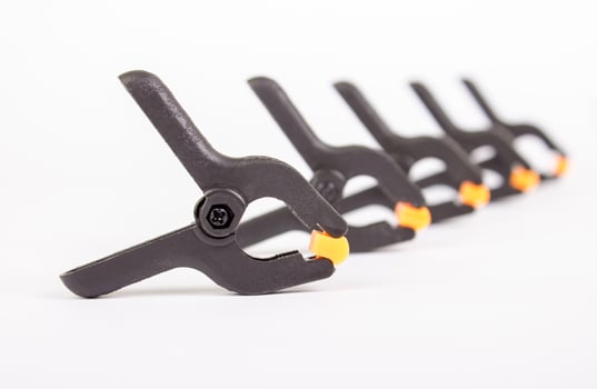Clothespin. Carpentry clamps. Plastic clothespin on a white. photo