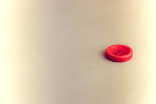 Beautiful texture with a round button for sewing, needlework. Copy space. Flat lay. Blue background photo