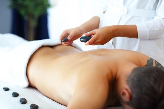 Handsome man having massage in spa salon photo