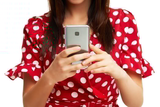 Caucasian brunette woman using smartphone isolated over white background photo