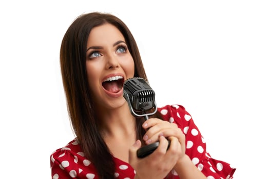 Caucasian brunette woman having fun and singing isolated over white background photo