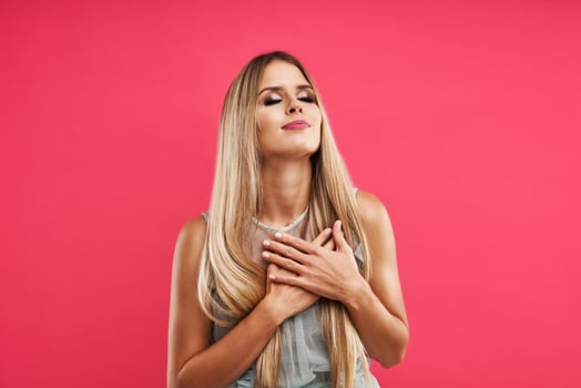 Beautiful adult woman posing over pink background photo