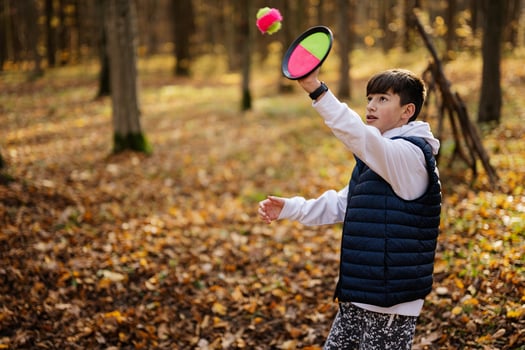 Autumn outdoor portrait of boy play with catch and toss ball game. photo