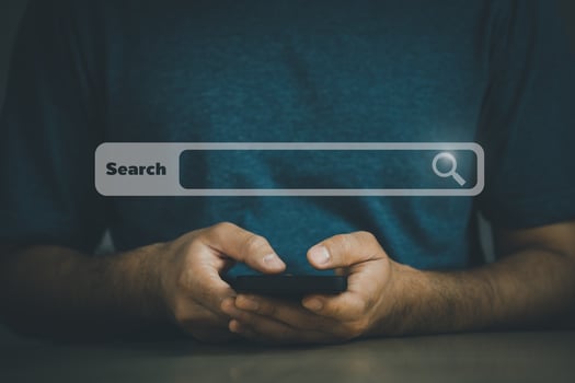 Businessman use mobile phone searching browsing internet data information with blank search bar. Search engine optimization SEO networking concept. businessman working with smartphone on desk. photo