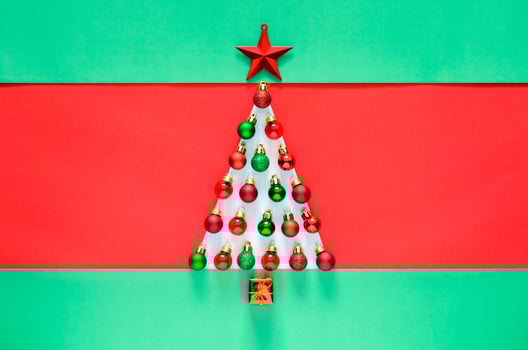 Christmas baubles ornament decorated as Christmas tree on red and green background. Minimal holiday concept. photo