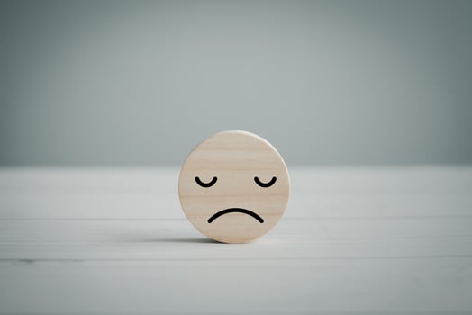 Unhappy face solitary on floor. Sadly, alone, insular, lonely. Emotion, Mental health assessment, World mental health day, Customer experience, Review, Feedback, Customer dissatisfaction client. photo