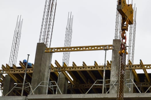 Construction of large modern monolithic frame houses, buildings using industrial construction equipment and large high cranes. Construction of the building in the new micro district of the city photo