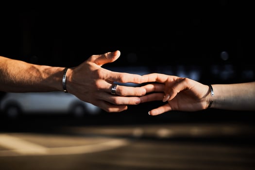the lovers' hands touch with their fingers photo