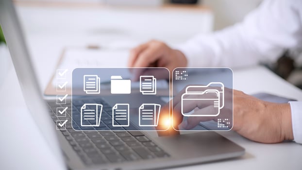 Document Management System DMS being setup by IT consultant working on laptop computer in office. Software for archiving, searching and managing corporate files and information photo