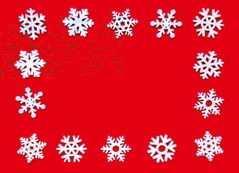 Snowflake frame on a red background, Christmas holiday composition top view, copy space photo