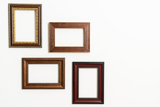 empty picture frame on white wall background photo