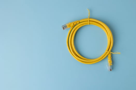 Closeup of yellow patch cord in blue background photo