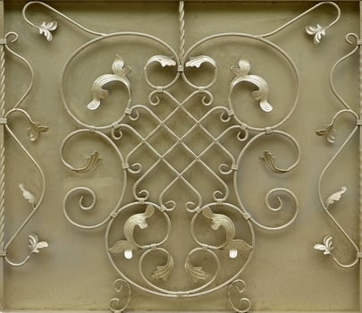 The texture of the golden metal gate with a beautiful floral pattern of forged metal photo