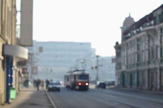Blurred landscape of highway with cars and tram in foggy morning photo