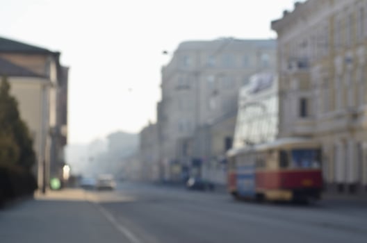 Blurred landscape of highway with cars and tram in foggy morning photo